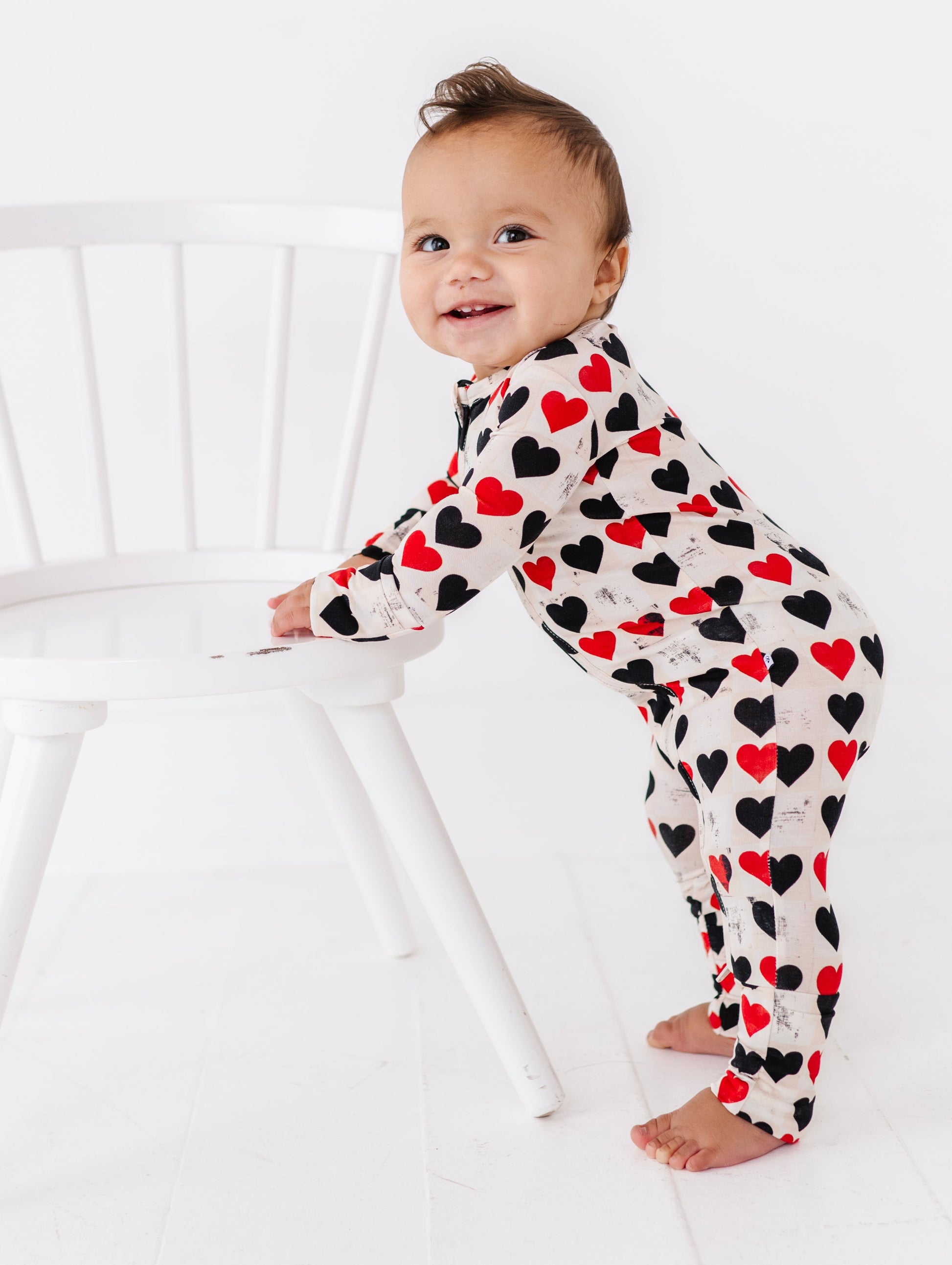 Baby standing in King of Hearts convertible romper with breathable bamboo material
