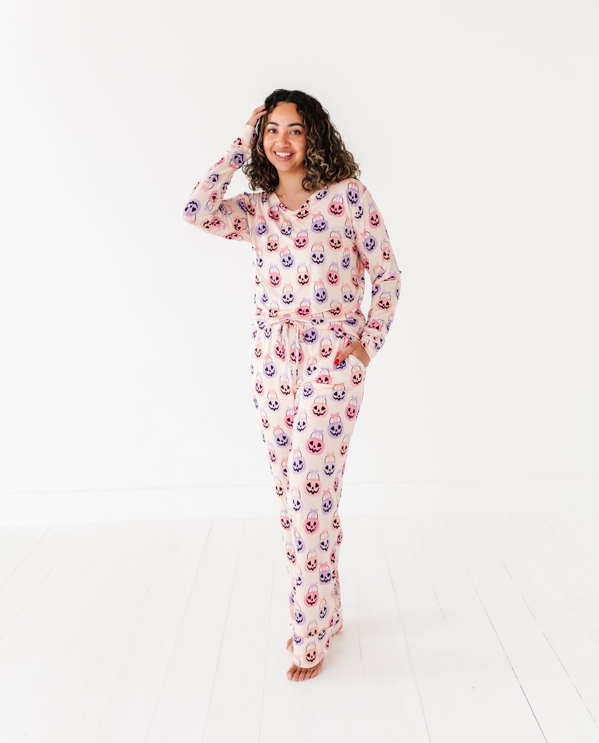 Woman wearing a Halloween bamboo pajama set on a white background