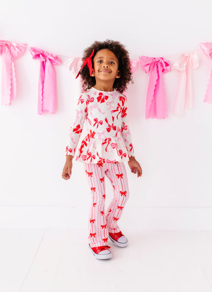 Front view of Blushing Bows long sleeve peplum top for girls