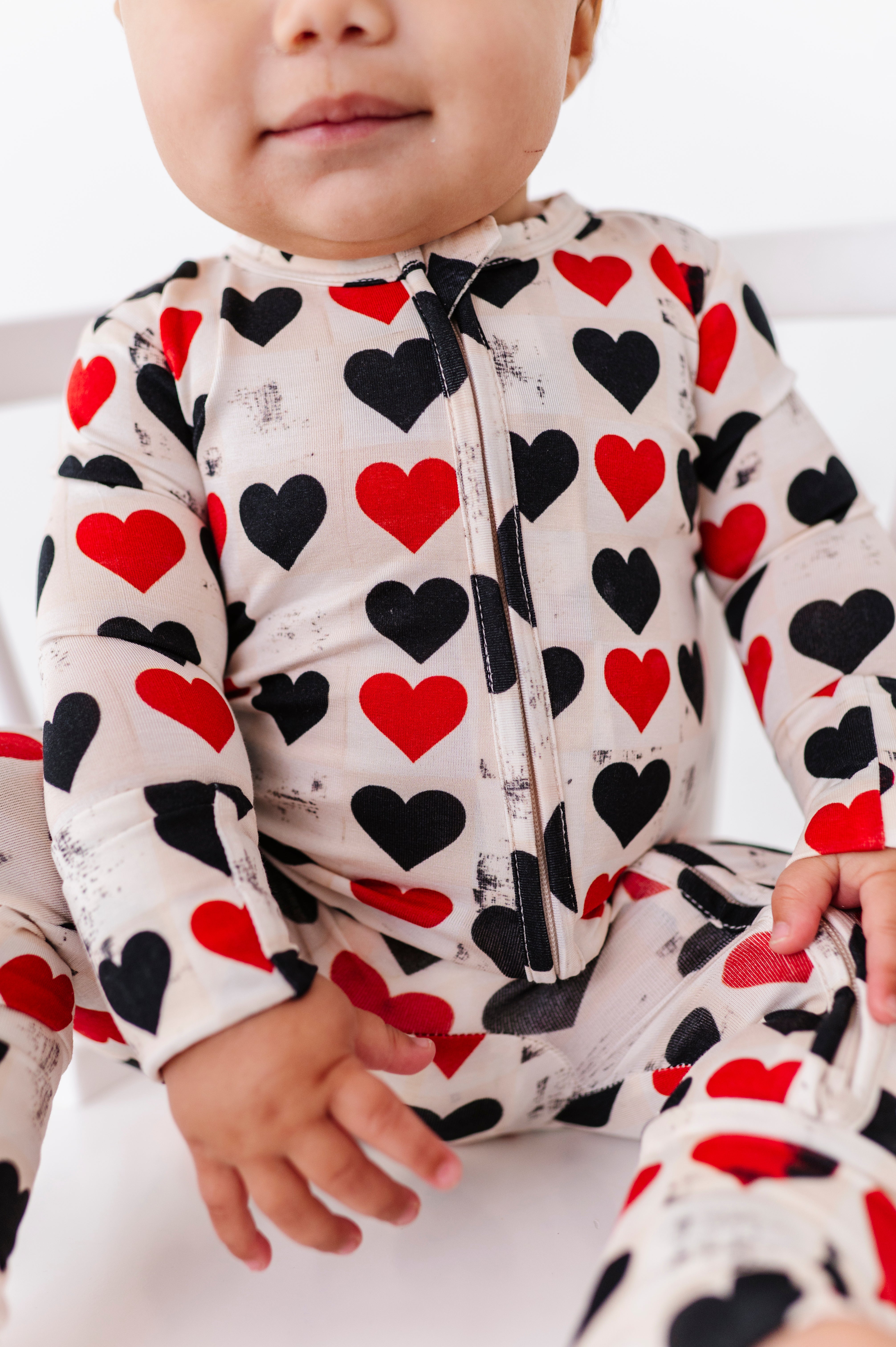 Close-up of King of Hearts bamboo romper showing 2-way zipper and heart pattern