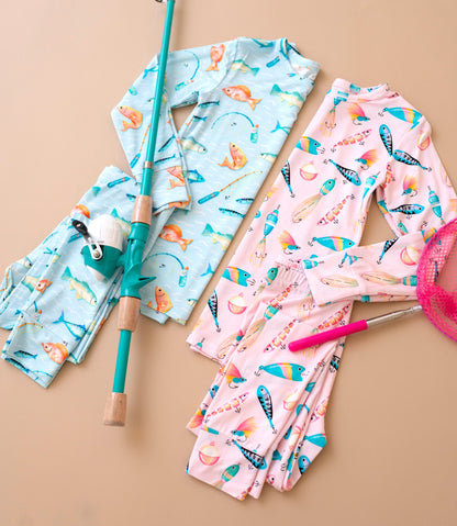Children's pajama set with fishing print on a beige background
