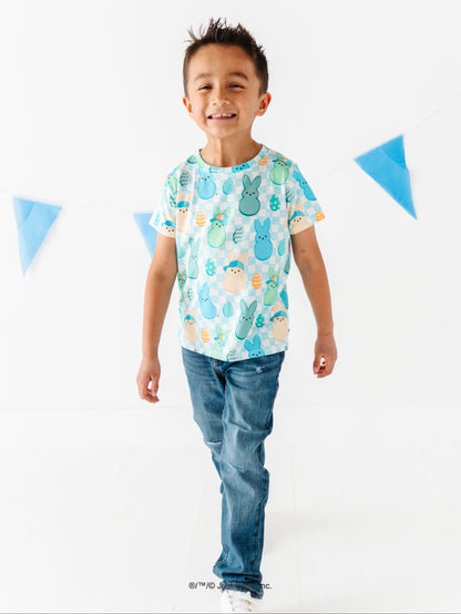 Child wearing a colorful t-shirt with a pattern of PEEPS® on a white background