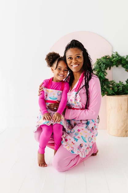 Matching mom and child Sugarplum holiday baking aprons in kitchen setting