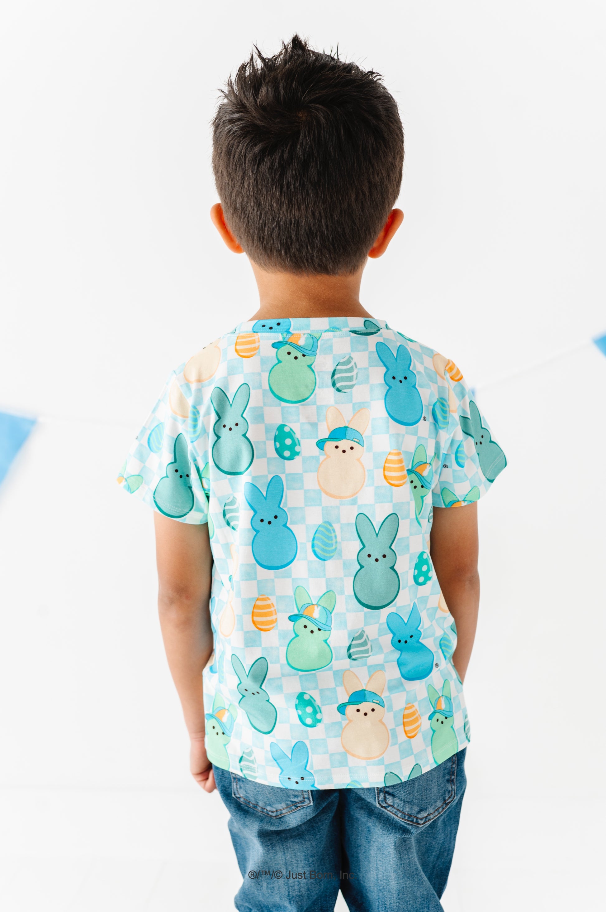 Child wearing a colorful shirt with PEEPS® on a white background