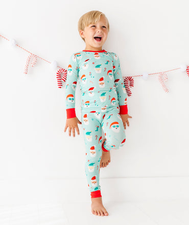 Child wearing a festive bamboo pajama set with a white background