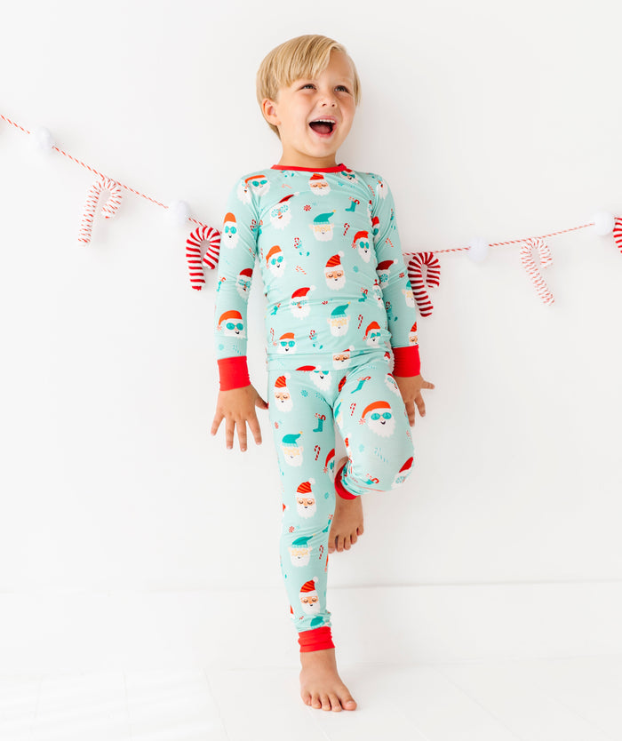 Child wearing a festive bamboo pajama set with a white background