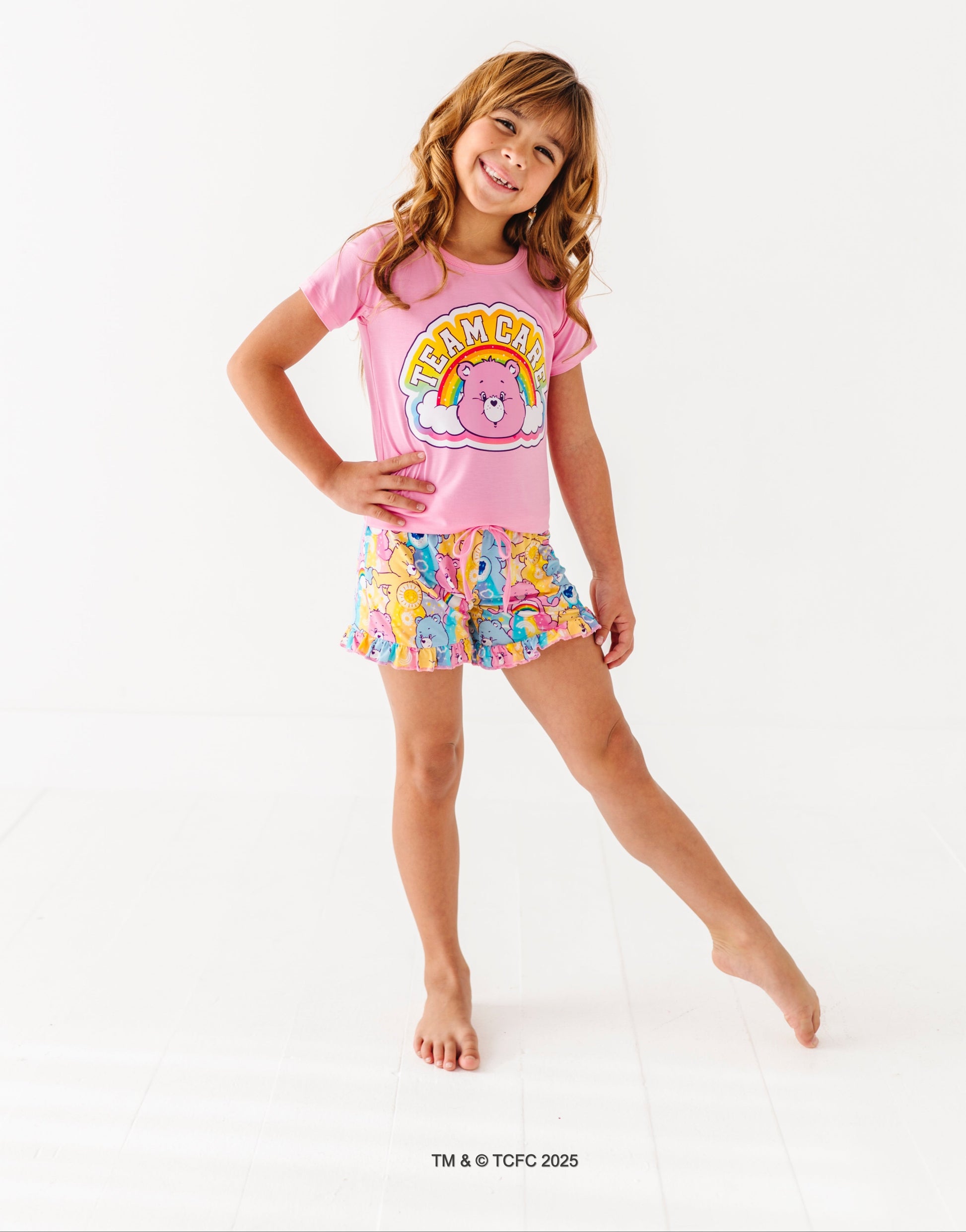 Care Bears™ Stare short-sleeve pajama top with rainbow bear graphic paired with printed lounge shorts