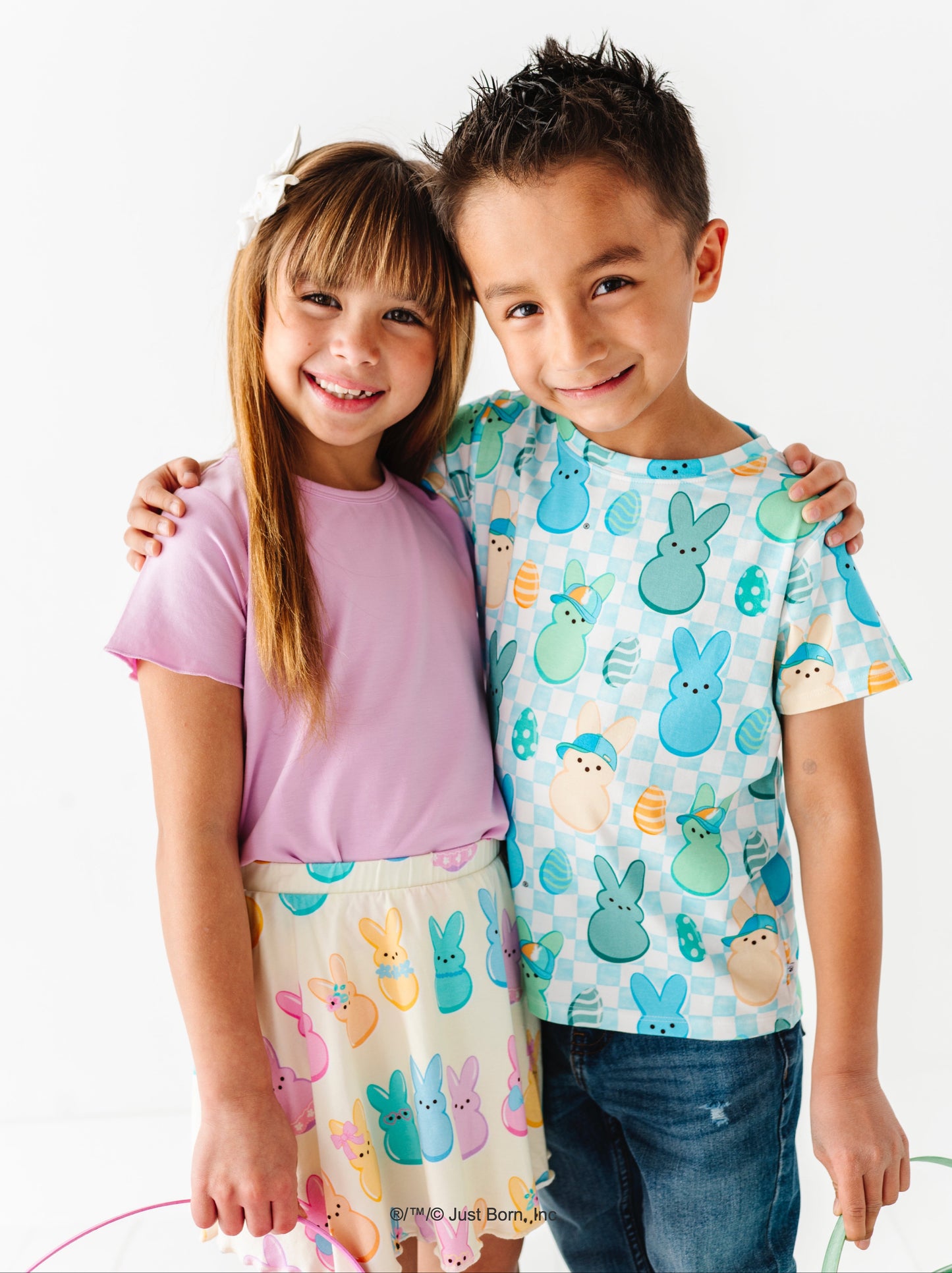 Two children wearing PEEPS®-themed clothing on a white background