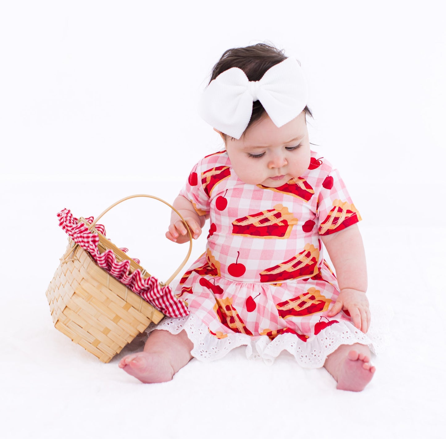 Infant wearing white bow headwrap with Birdie Bean bamboo outfit