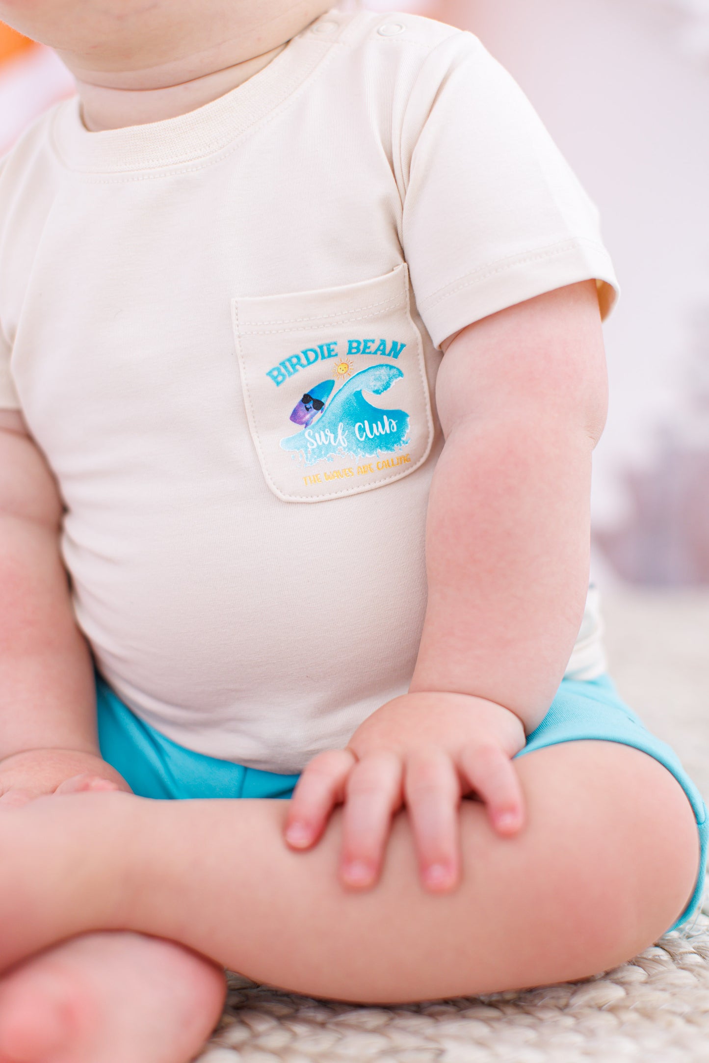 Up-close shot of a baby wearing a beach focused graphic tee 