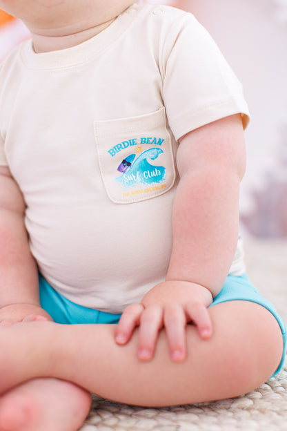 Up-close shot of a baby wearing a beach focused graphic tee 