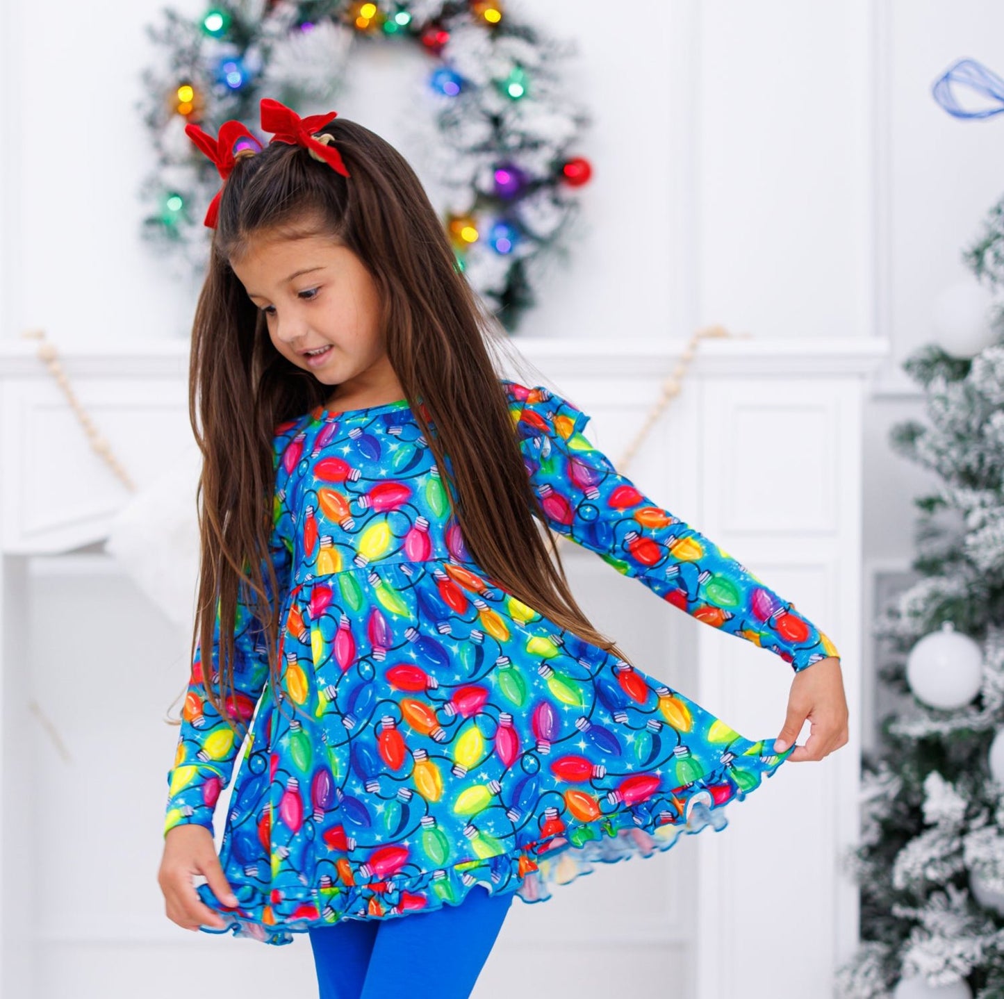 Little girl wearing holiday lights peplum set with a red velvet headband 