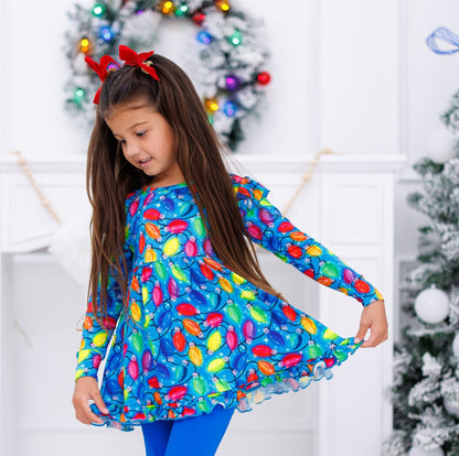 Little girl wearing holiday lights peplum set with a red velvet headband 