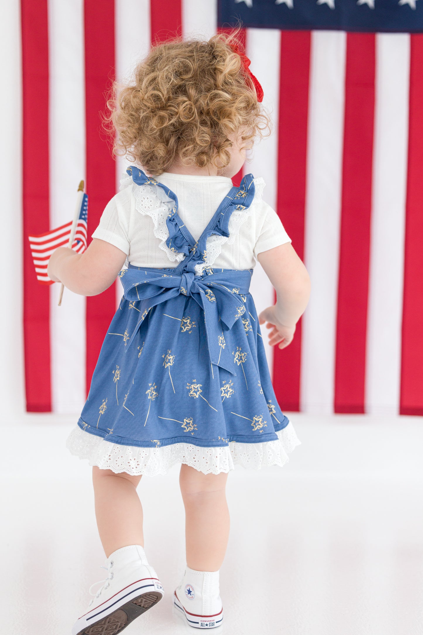 Detail of ruffle straps and eyelet lace hem on girls twirl dress