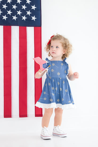 Toddler girl in blue patriotic twirl dress with ruffle straps and eyelet hem