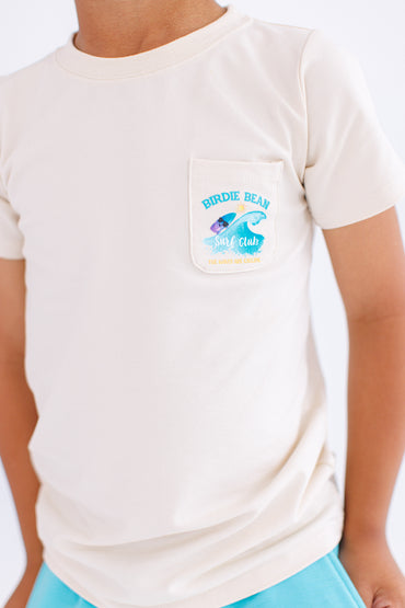 Beige t-shirt with 'Birdie Bean Surf Club' on front pocket