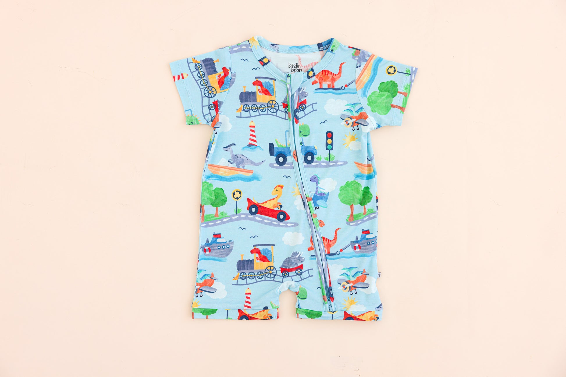 Children's bamboo romper with vehicle and animal pattern on a beige background