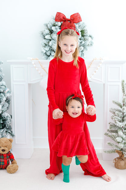 Sisters wearing matching red velvet styles for the holidays 