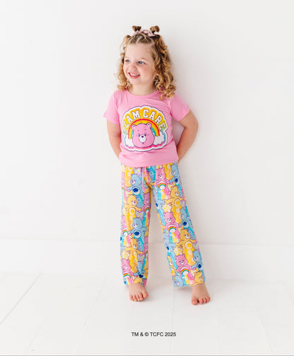 Care Bears™ Stare short-sleeve pajama top with rainbow bear graphic paired with printed lounge bottoms