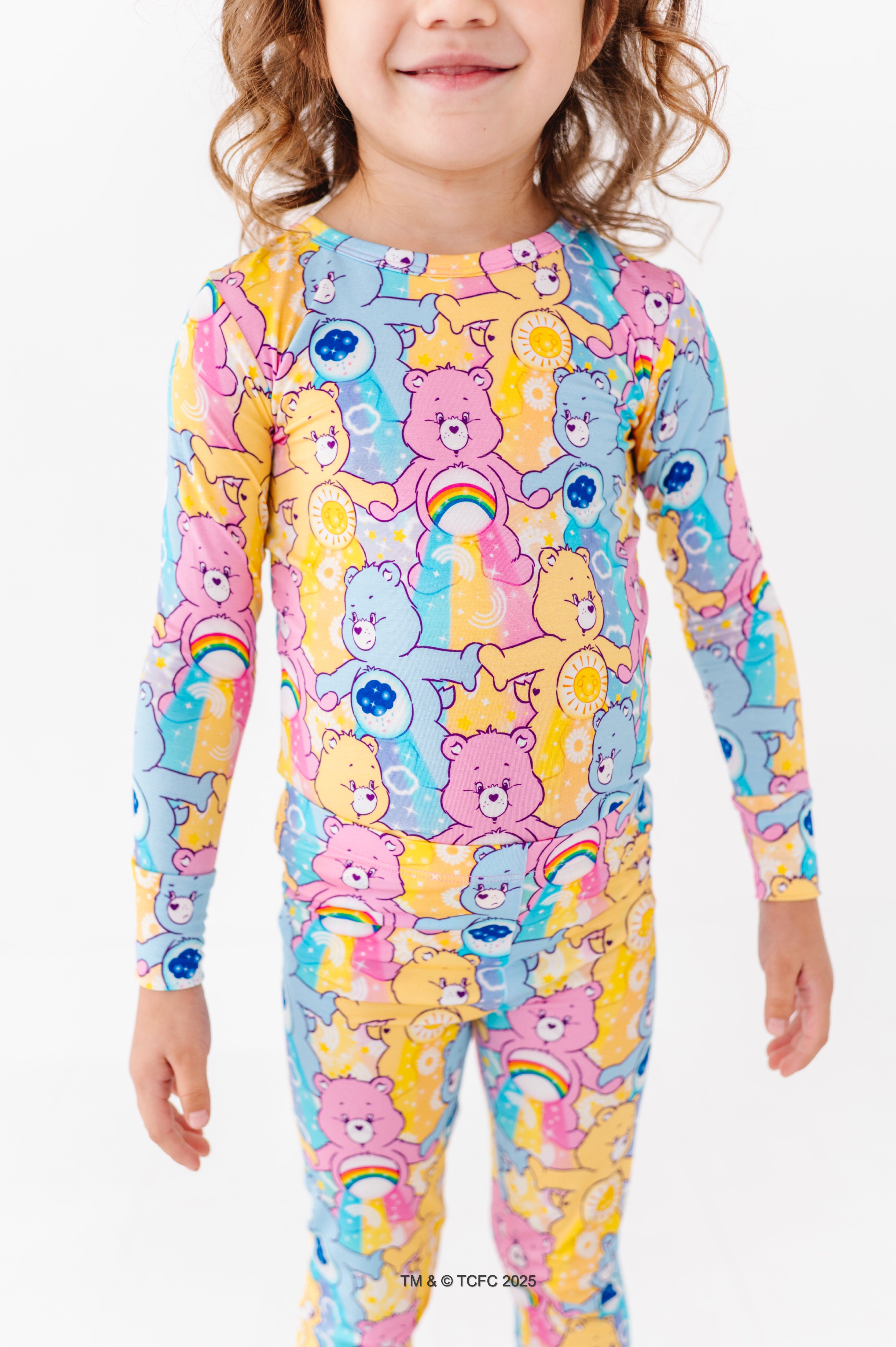 Close-up of Care Bears™ Stare pajama set showing vibrant bear characters and belly badge details