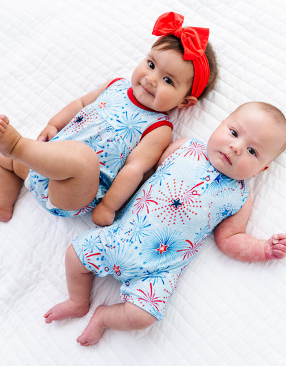 Two babies wearing matching bamboo rompers for the 4th of July