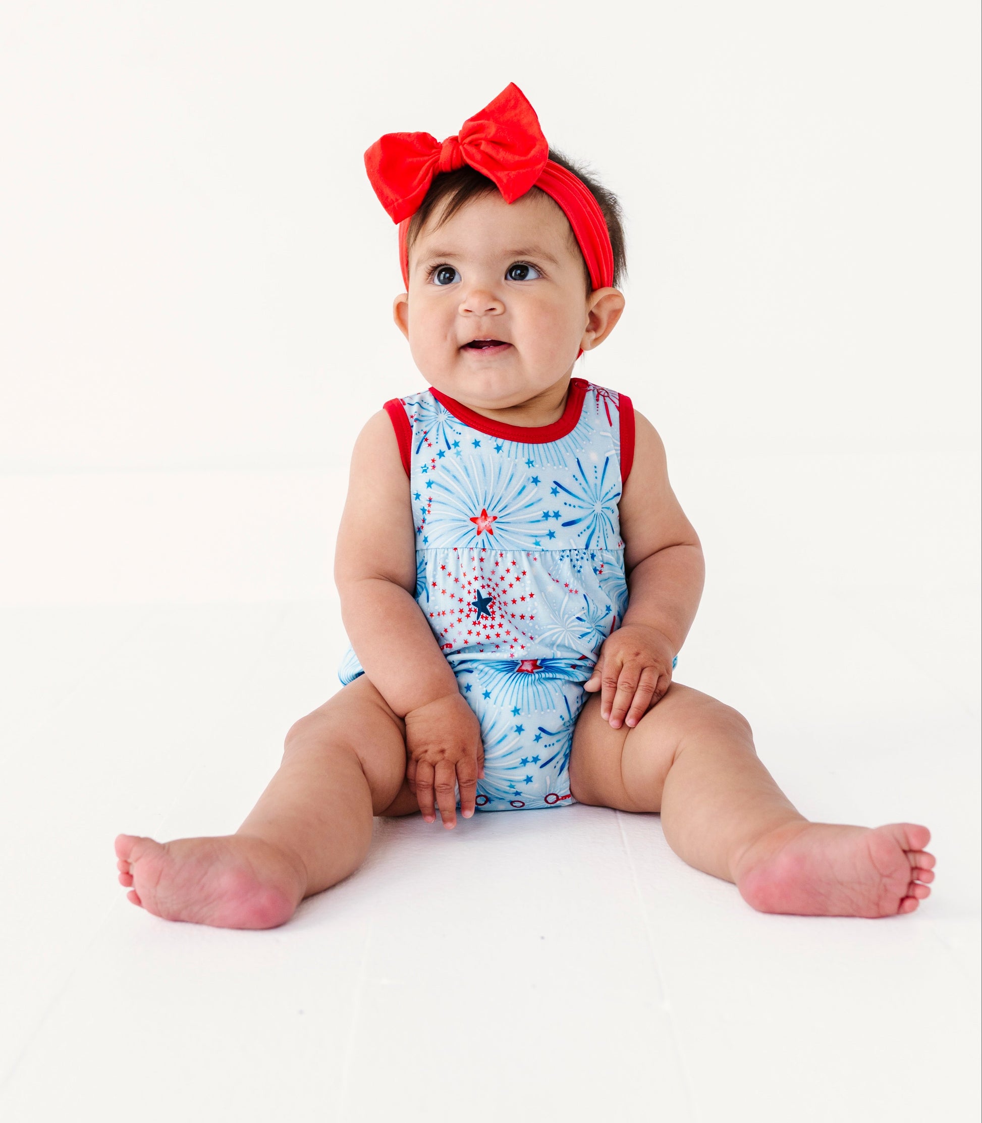 Baby wearing a patriotic bamboo bubble romper on a white background