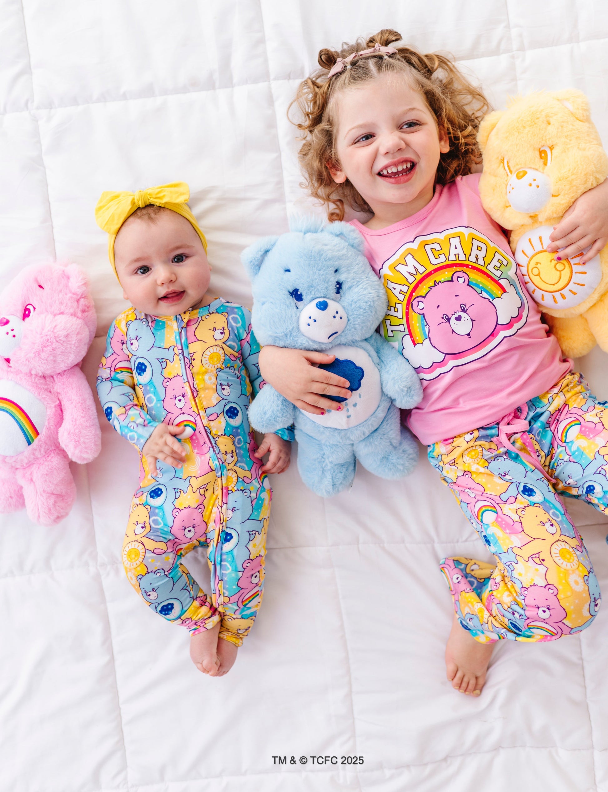Two children in Care Bears-themed bamboo pajamas 