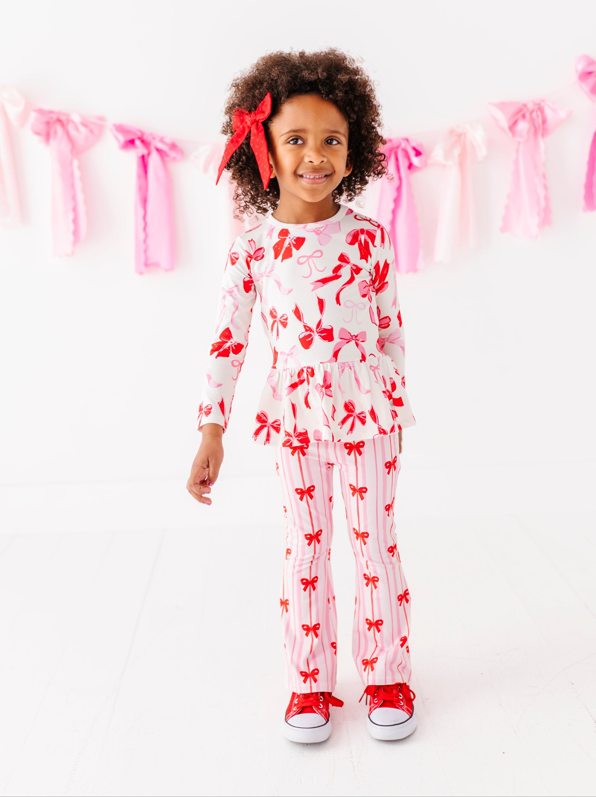 Everyday kids pants with red and pink ribbon pattern styled for Valentine’s Day