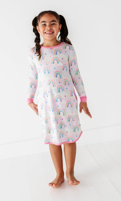 Little girl wearing a Birdie gown for lounging, featuring watercolor rainbows on super soft bamboo fabric