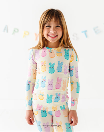 Child wearing a colorful Peeps-themed pajamas with a white background