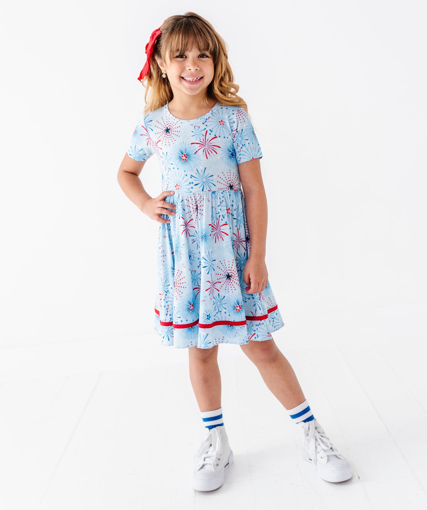 Young girl wearing a light blue bamboo dress on a white background