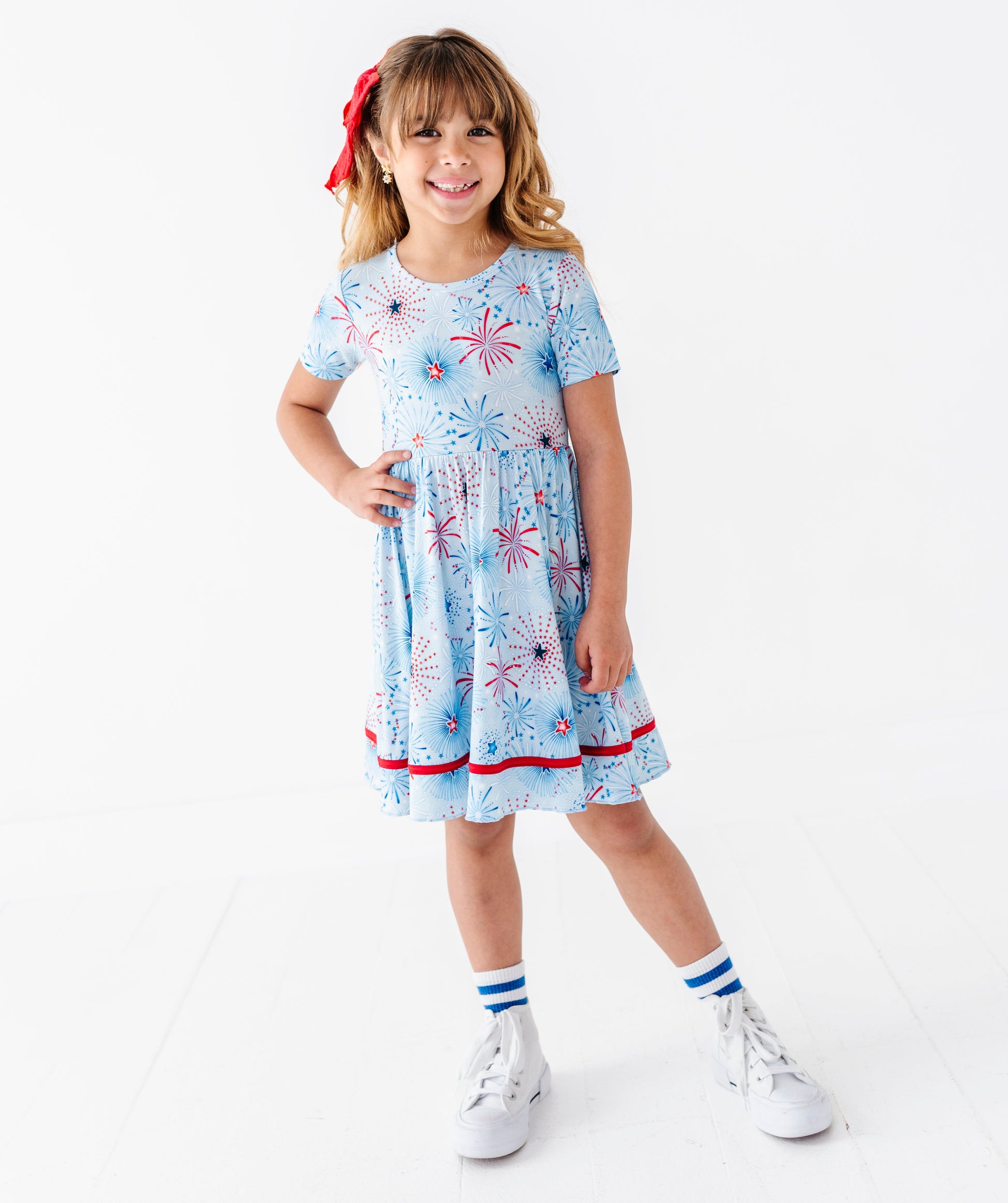 Young girl wearing a light blue bamboo dress on a white background