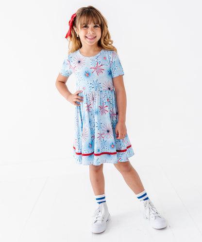 Young girl wearing a light blue bamboo dress on a white background