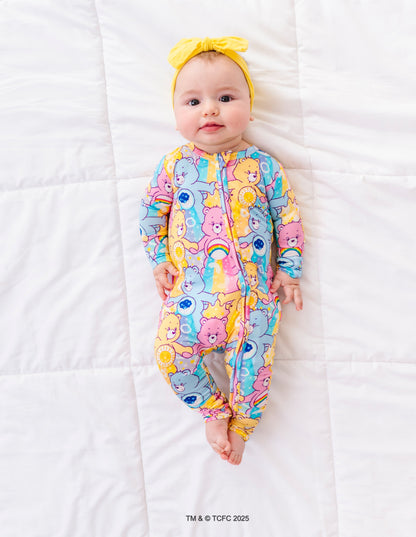 Infant wearing Care Bears™ Stare romper with convertible feet and snug sleep-safe fit