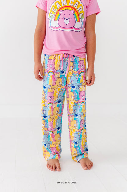 Close-up of Care Bears™ Stare lounge pants featuring colorful bear, rainbow, and cloud print  