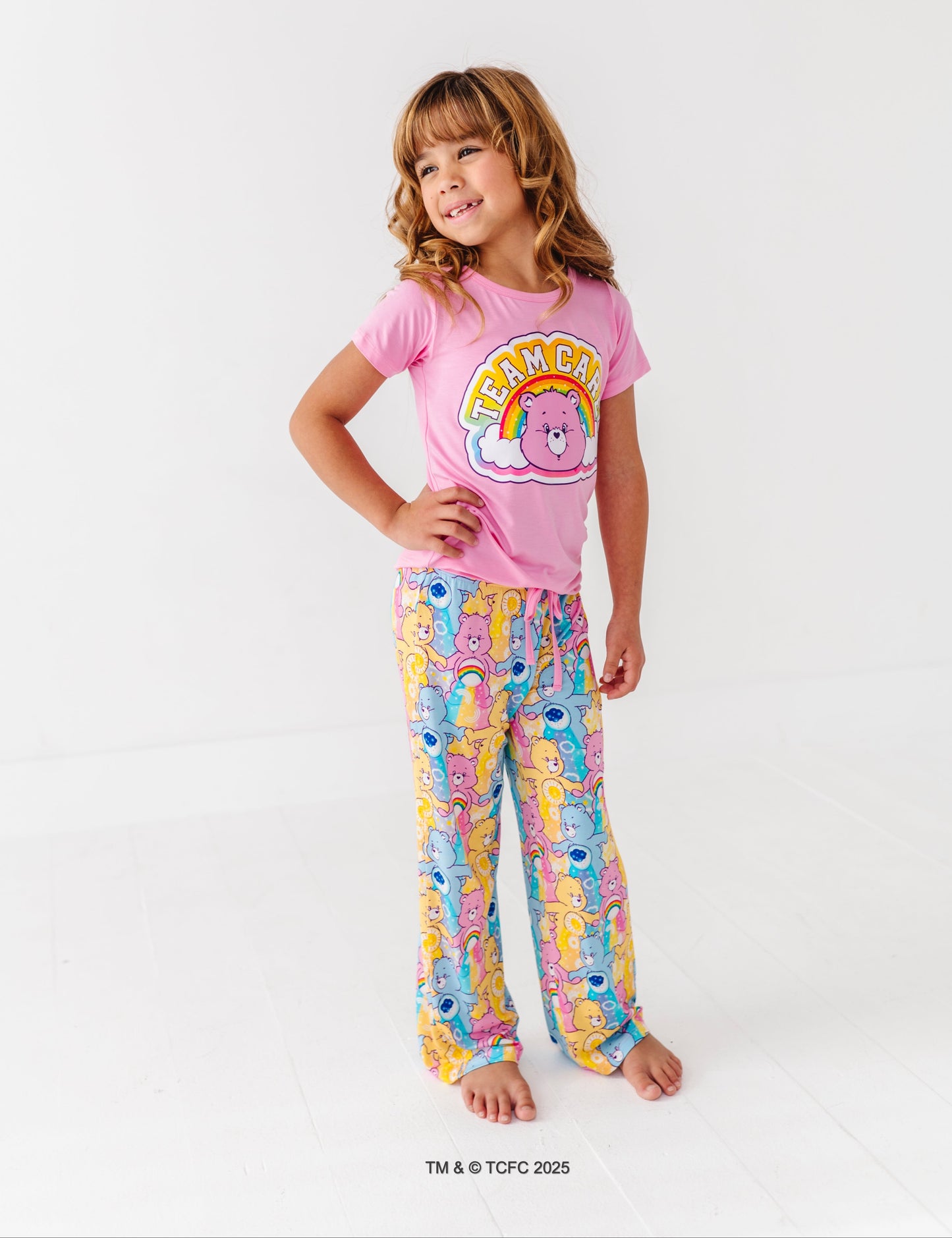 Care Bears™ Stare short-sleeve pajama top with rainbow bear graphic paired with printed lounge bottoms