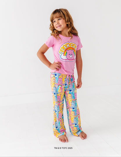 Care Bears™ Stare short-sleeve pajama top with rainbow bear graphic paired with printed lounge bottoms