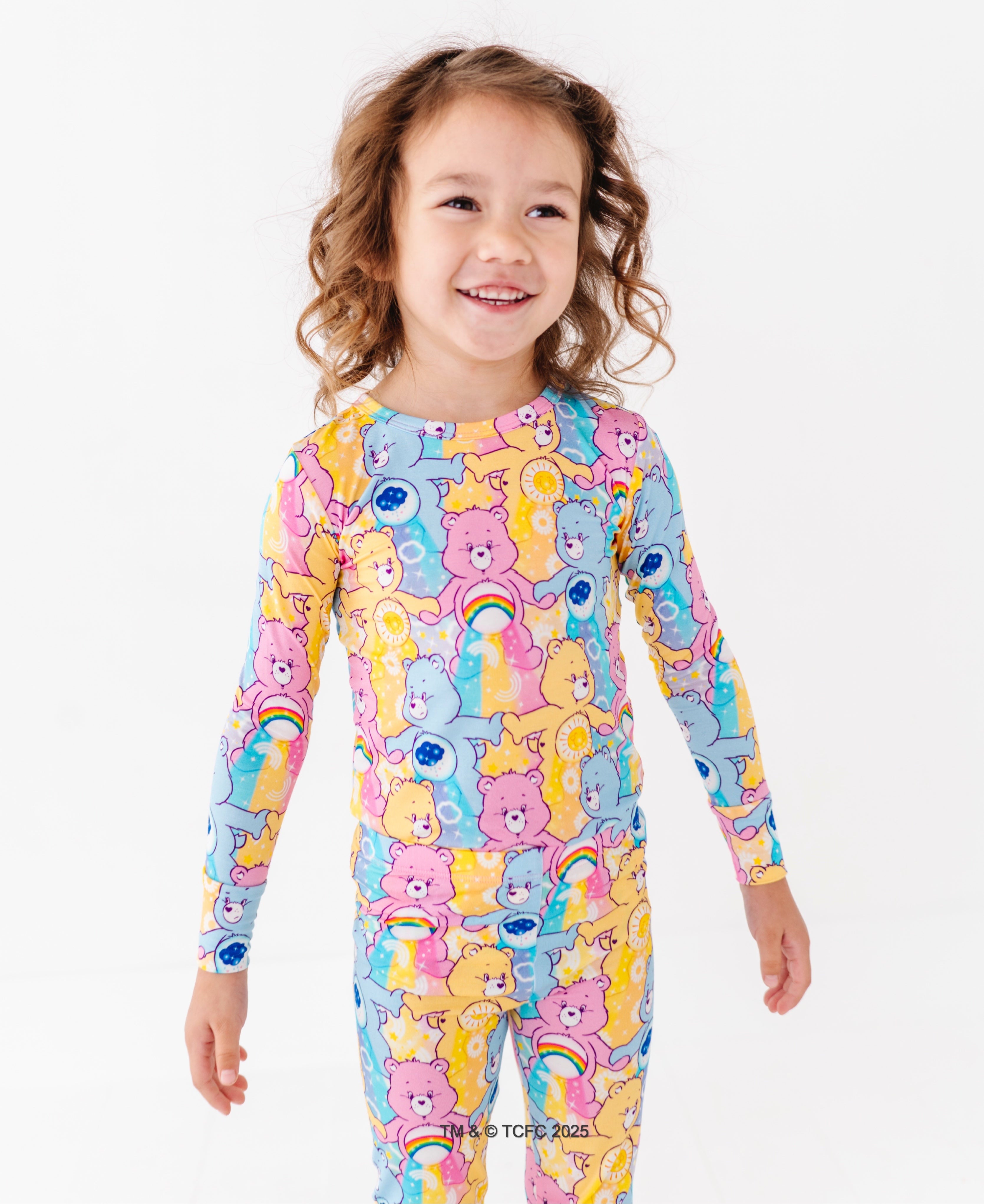 Care Bears™ bamboo pajamas for toddlers with rainbow, sun, and cloud character details