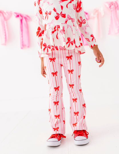 Pink striped bamboo cotton pants with red bow print on toddler