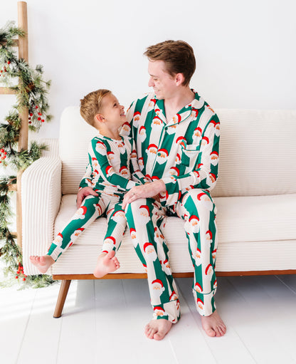 Dad and son wearing matching green stripe bamboo pajamas featuring Santa Claus 
