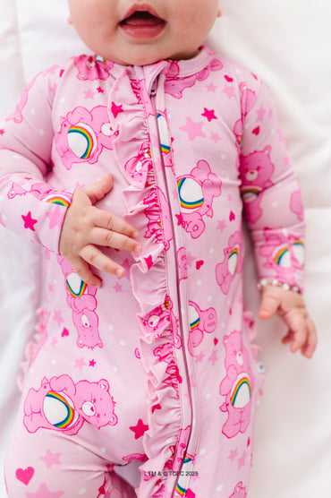 Close-up of pink Care Bears Cheer Bear convertible romper with ruffled zipper front