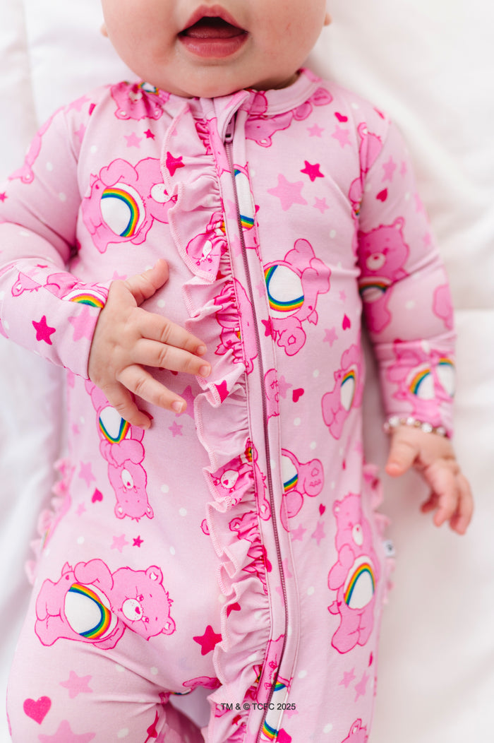 Close-up of pink Care Bears Cheer Bear convertible romper with ruffled zipper front