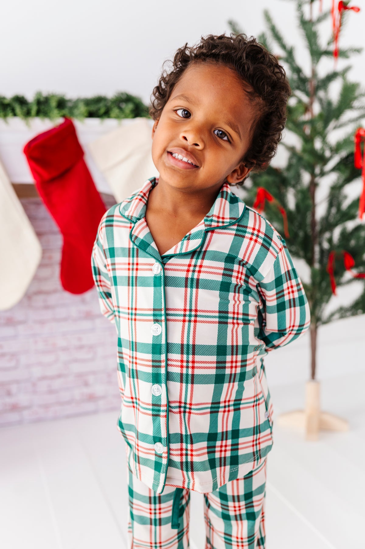 A little boy wearing a classic Christmas plaid print in bamboo lounge pajamas 