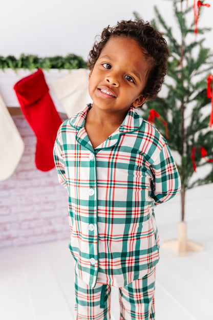 A little boy wearing a classic Christmas plaid print in bamboo lounge pajamas 