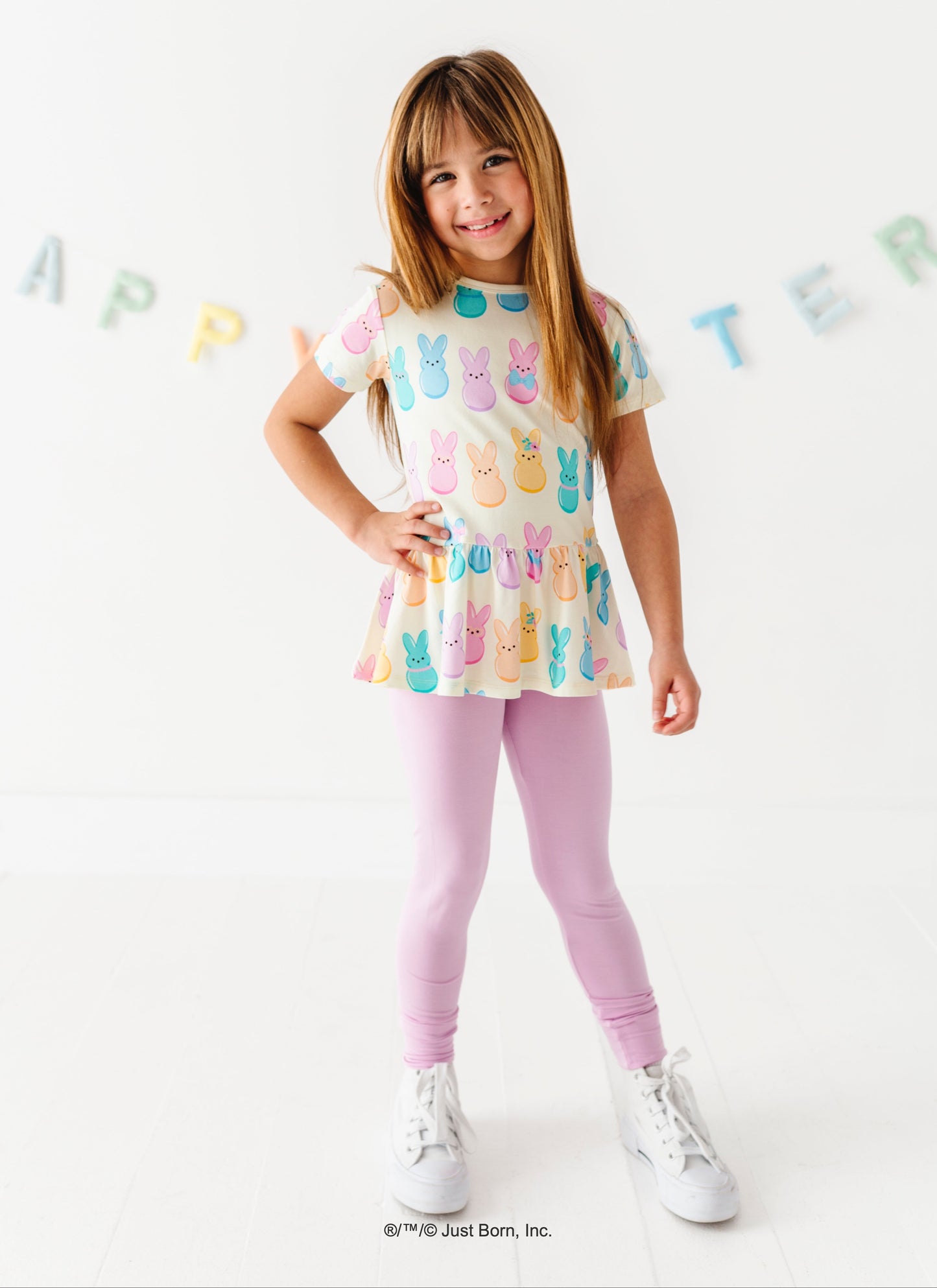 Young girl wearing a colorful top with PEEPS®  design on a white background