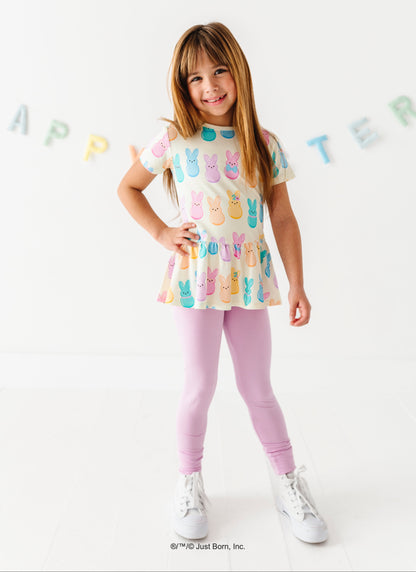 Young girl wearing a colorful top with PEEPS®  design on a white background
