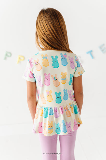 Child wearing a top with Peeps character print on a white background
