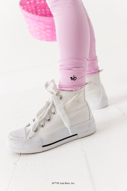 White high-top sneakers with a logo on legging cuff on a white background