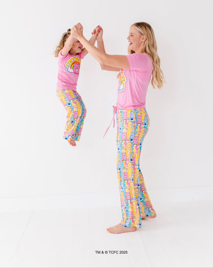Matching mom and toddler wearing Care Bears bamboo pajama sets on white background