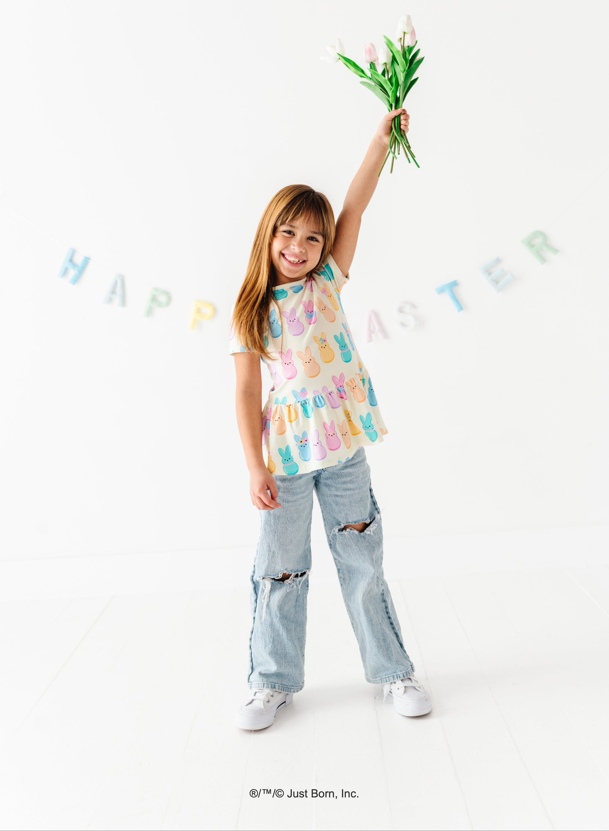 Child holding tulips with 'Happy Easter' banner on a white background